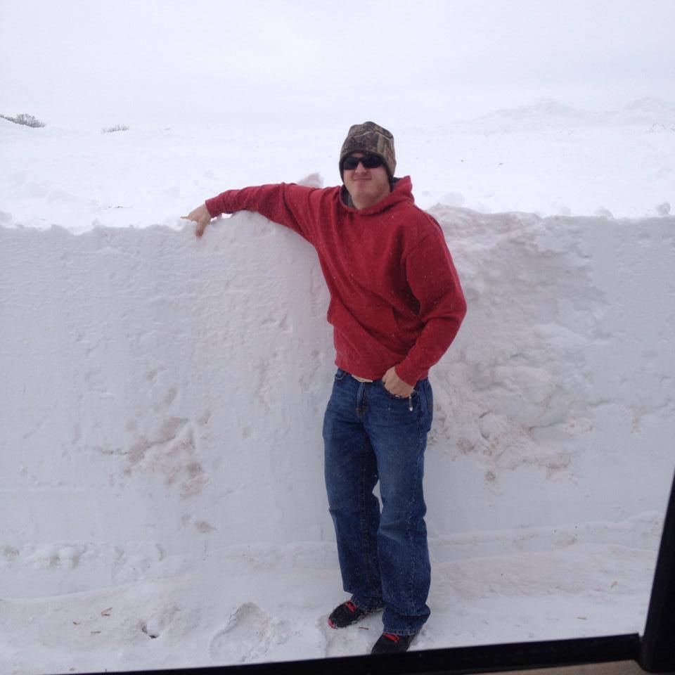 man standing by a lot of snow man standing by a lot of snow