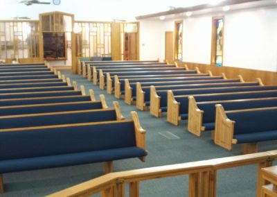 rows of pews with blue fabric