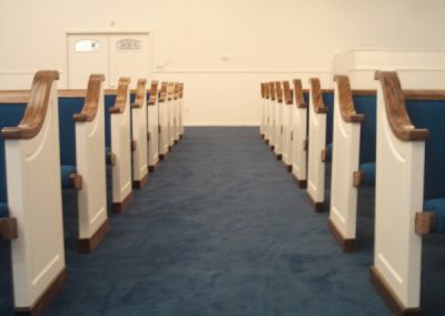 white church pews with blue cushions