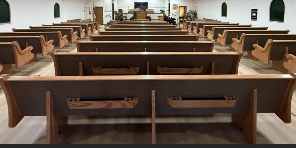 Church pew backside showing Bookracks with cup and card slots
